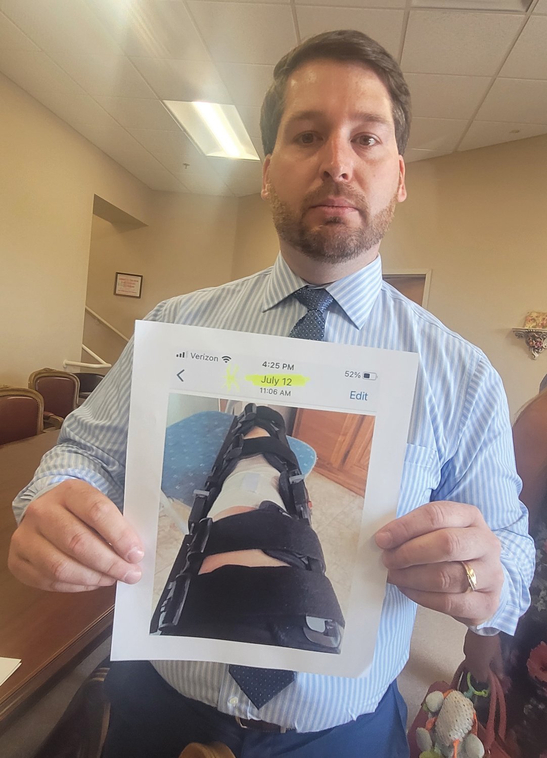 AILING MOM: Dennis Cardillo Jr. holds a photograph of what he says is his mother’s post-operative injury dated July 12. The candidate for state representative in District 42 has been accused of living outside the district. He insists he was merely taking care of his mother in Cranston while she recuperated.